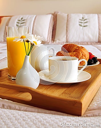 Breakfast on a bed in a hotel room