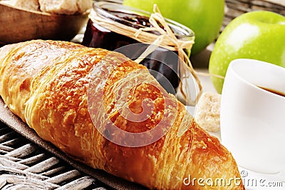 Breakfast with coffee, fresh croissant and fruits