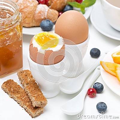 Breakfast with eggs, toasts, croissants, fresh berries