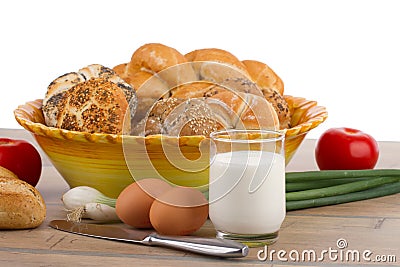 Breakfast menu - fresh buns, milk, eggs and tomatoes