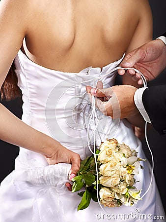 Bridal trying on wedding dress.