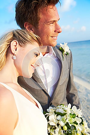 Bride And Groom Getting Married In Beach Ceremony