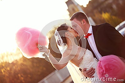 Bride and groom holding a candy floss