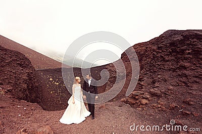 Bride and groom love on mountain