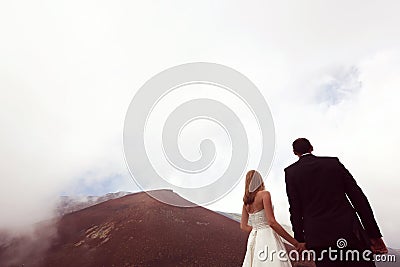Bride and groom love on mountain