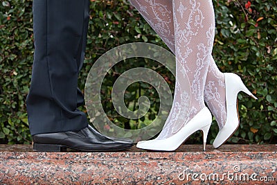 Bride and groom shoes closeup on marble on nature background.