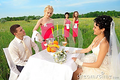 Bride and groom sitting at wedding table