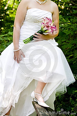 Bride showing off wedding dress and shoes