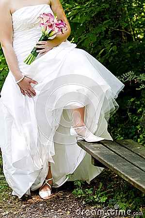 Bride showing off wedding dress and shoes