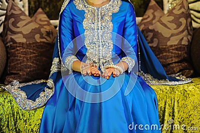 Bride Wearing a blue dress sitting on an altar, head not seen