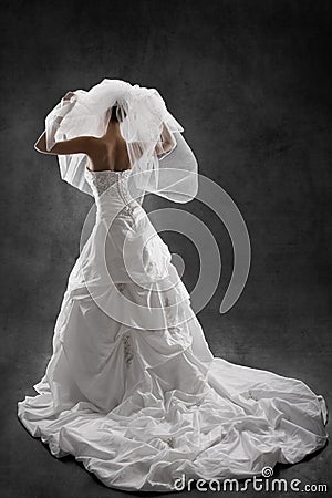 Bride in wedding luxury dress, back view. Black background