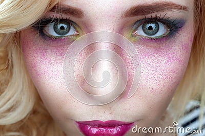 Bright creative make-up on woman face with powder on skin
