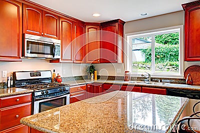 Bright kitchen room with cherry wood storage combination