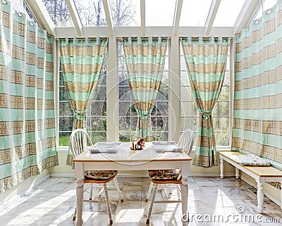 Bright sun room with dining table set