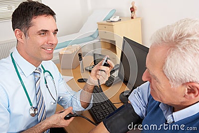 British doctor taking man s blood pressure