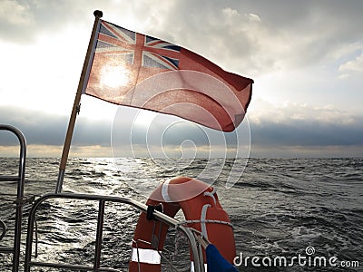British maritime ensign flag boat and stormy sky