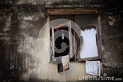 Broke wooden windows with hanging cloths