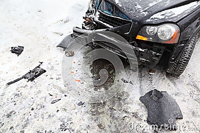 Broken black car on road in winter