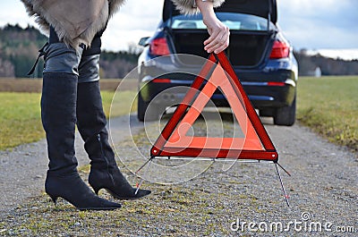 Broken car, girl and triangle