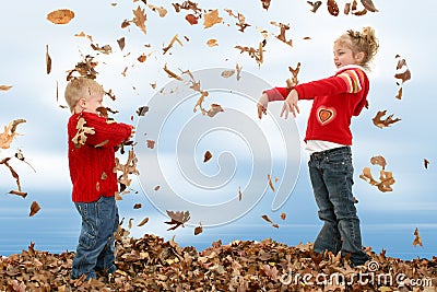 Brother and Sister Throwing Leaves
