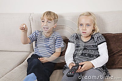 Brother and sister watching television