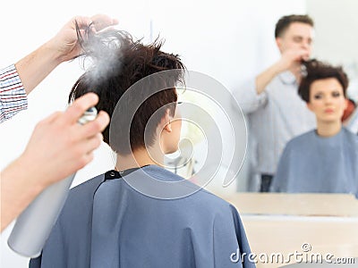 Brown Hair. The Hairdresser doing Hairstyle in Hair Salon.