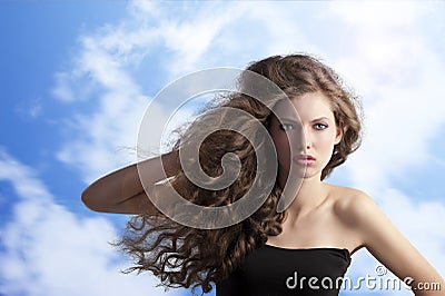 Brunette with creative hairstyle in sky