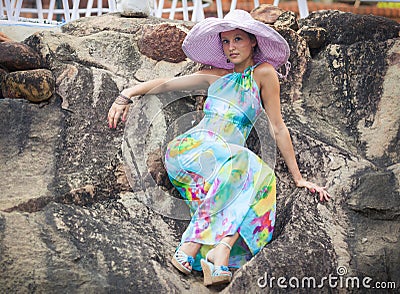 Brunette girl in flower dress and pink hat