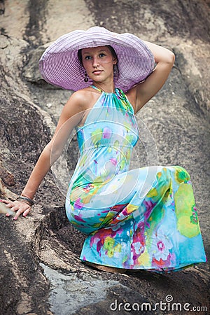 Brunette girl in flower dress and pink hat