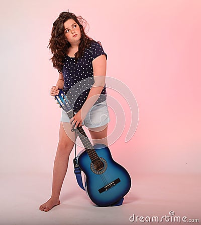 Brunette girl playing blue guitar