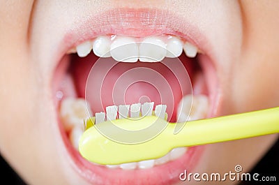 Brushing teeth with toothbrush
