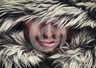 Brutal face of man with beard bristles and hooded winter