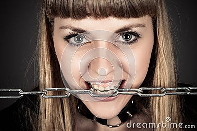 Brutal woman with a chain in teeth