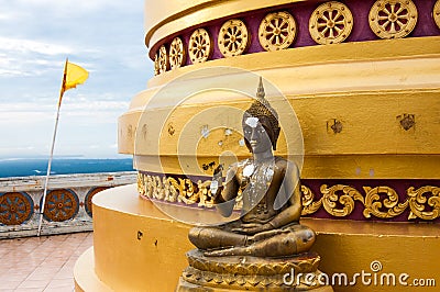 Buddha statue at base of pagoda at hilltop temple