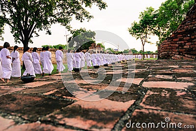 Buddhist peoples walk and pray around temple