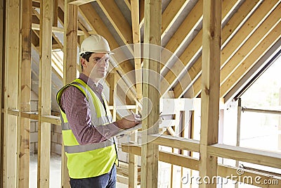 Building Inspector Looking At New Property