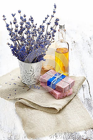 Bunch of lavender flowers,soap on old wooden background.Spa tre