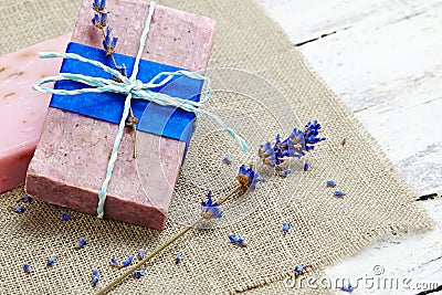 Bunch of lavender flowers,soap on old wooden background.Spa tre