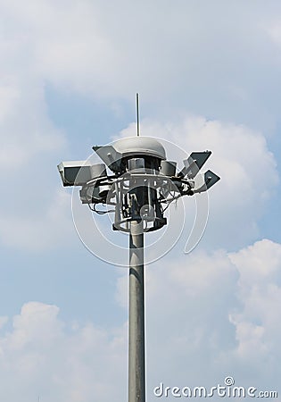 Bunch spot-light pole tower in blue sky