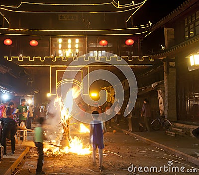 Burning Torch in Front of Chinese Gate
