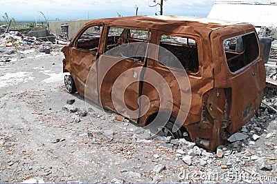 Burnt car wreck after volcano eruption