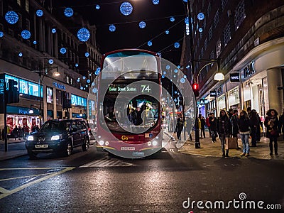 Bus on Oxford Street, surrounded by shopping crowds, Christmas week, London, England