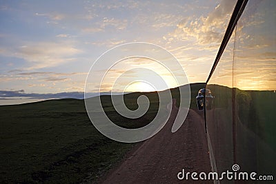 Bus on the road at sunrise