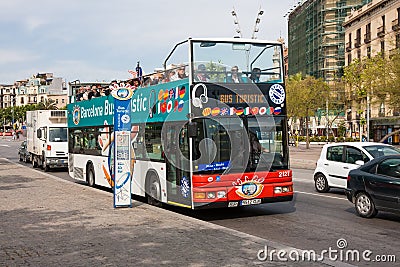 Bus stop and sightseeing bus with tourists in Barcelona, Spain