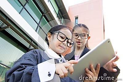 Business Asian child using tablet