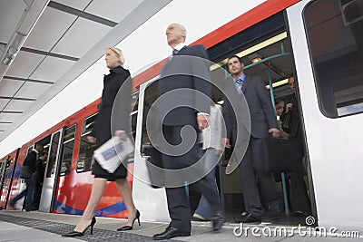 Business Commuters Getting Off Train