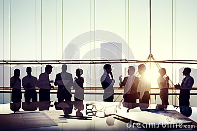 Business Discussing at Sunset Reflected onto Table