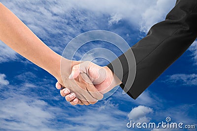 Business hand shake on a summer clouds background