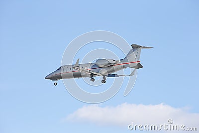 Business jet taking off isolated on a blue sky background.