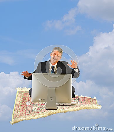 Business man with computer on a magic carpet ride